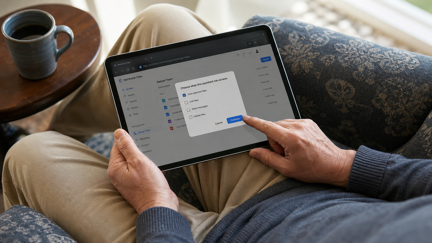 A person reviews tablet permissions with view selected while edit, send, and delete remain off.